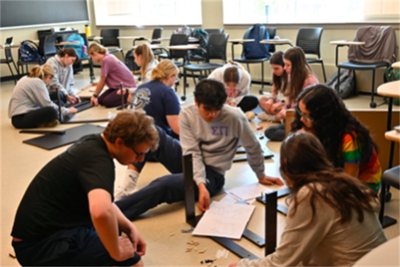 Students participate in the classroom hands-on learning experience of assembling IKEA furniture.